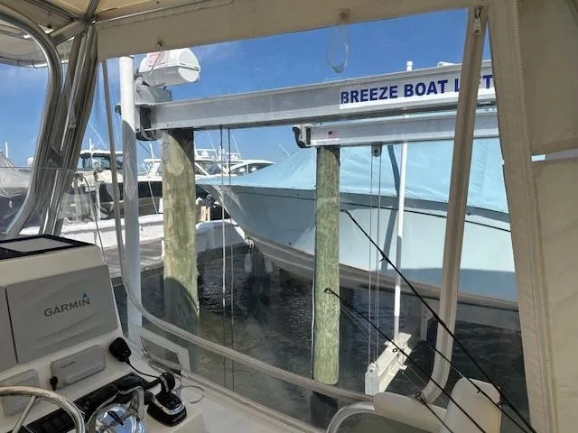Slide: The Image of 2021 AmeraCat 27 Gen II DC on boat lift, viewed from cockpit with Garmin equipment. - 19