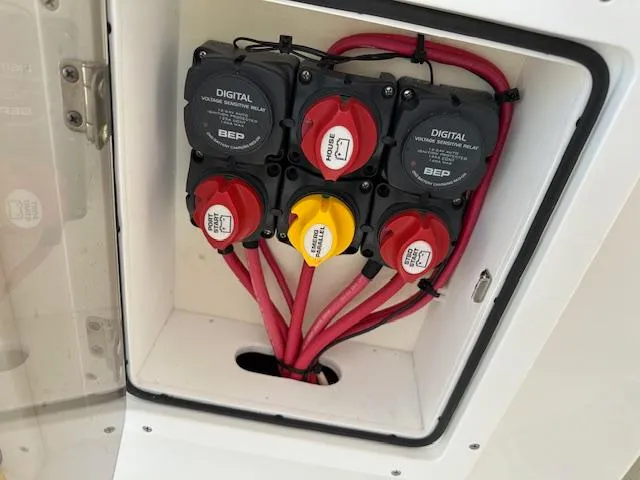 Slide: The Image of Electrical panel with switches and cables on a 2021 AmeraCat 27 Gen II DC boat. - 22