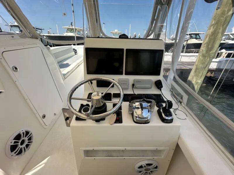 Slide: The Image of 2021 AmeraCat 27 Gen II DC boat helm with dual screens and controls. - 24