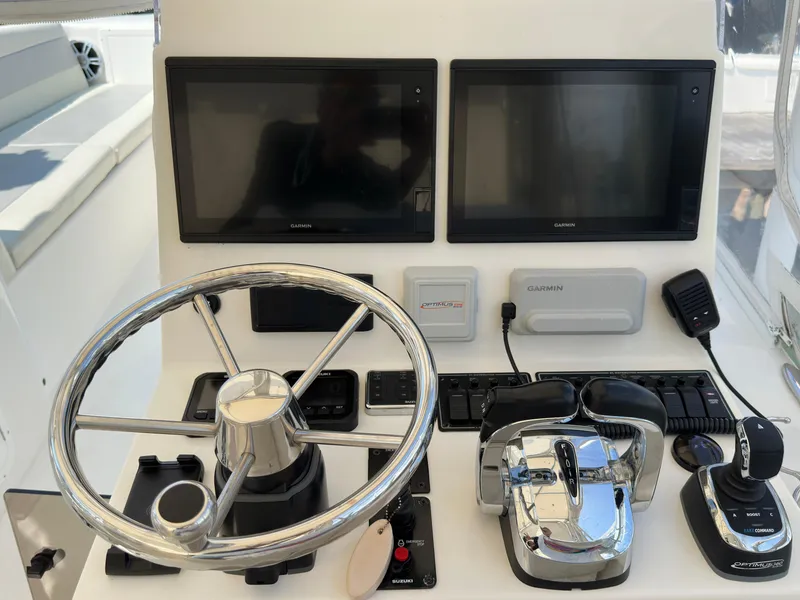 Slide: The Image of 2021 AmeraCat 27 Gen II DC helm with dual Garmin displays and chrome steering wheel. - 25