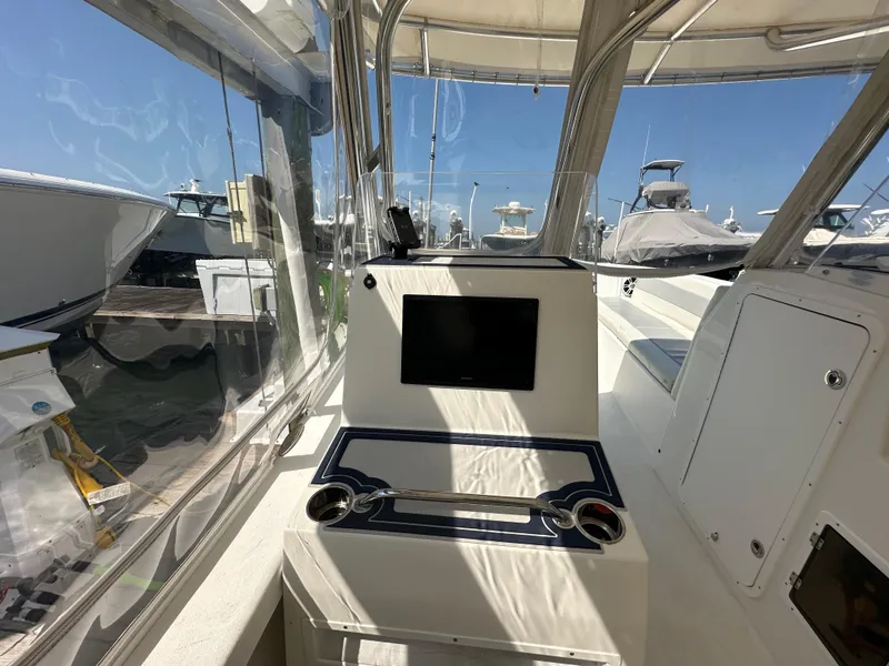 Slide: The Image of 2021 AmeraCat 27 Gen II DC boat interior with control panel and seating area. - 26