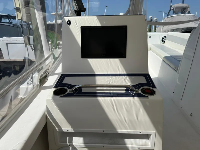 Slide: The Image of 2021 AmeraCat 27 Gen II DC boat interior with screen and cup holders. - 27