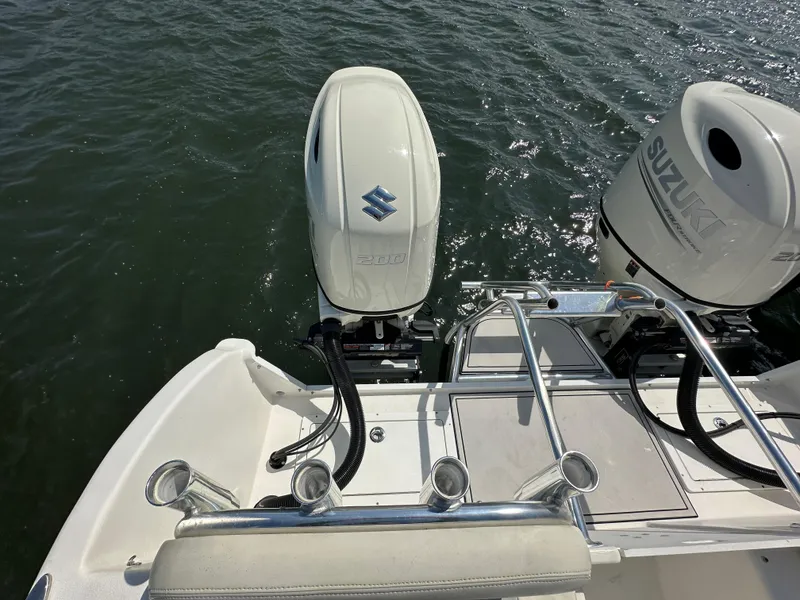 Slide: The Image of 2021 AmeraCat 27 Gen II DC boat with dual Suzuki outboard motors on water. - 29