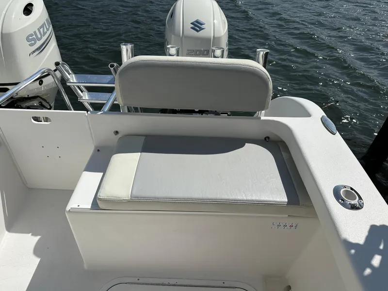 Slide: The Image of 2021 AmeraCat 27 Gen II DC boat with Suzuki outboard engines, featuring a cushioned seating area. - 31