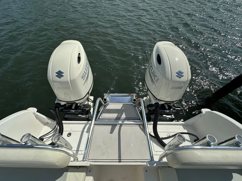 Slide: The Image of 2021 AmeraCat 27 Gen II DC boat with twin Suzuki outboard motors on water. - 34