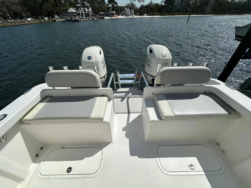 Slide: The Image of 2021 AmeraCat 27 Gen II DC boat with dual outboard motors on a sunny waterfront. - 35