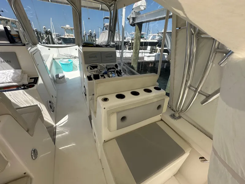Slide: The Image of 2021 AmeraCat 27 Gen II DC boat interior with seating and helm, docked at marina. - 36