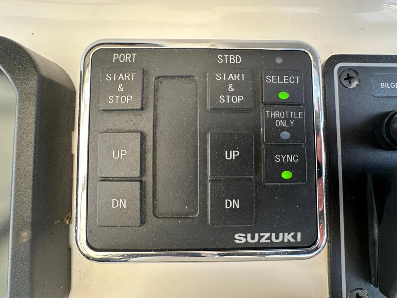 Slide: The Image of Control panel of a 2021 AmeraCat 27 Gen II DC boat with Suzuki engine controls. - 43