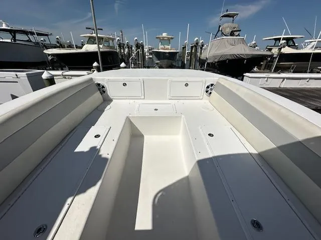 Slide: The Image of 2021 AmeraCat 27 Gen II DC boat interior at marina, showcasing spacious seating and storage. - 5