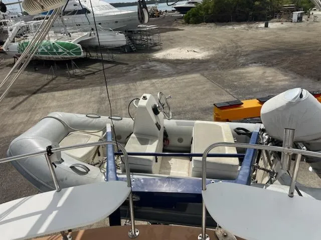 Slide: The Image of Seaton Custom Ketch 2014 with inflatable dinghy on deck, docked at a marina. - 12