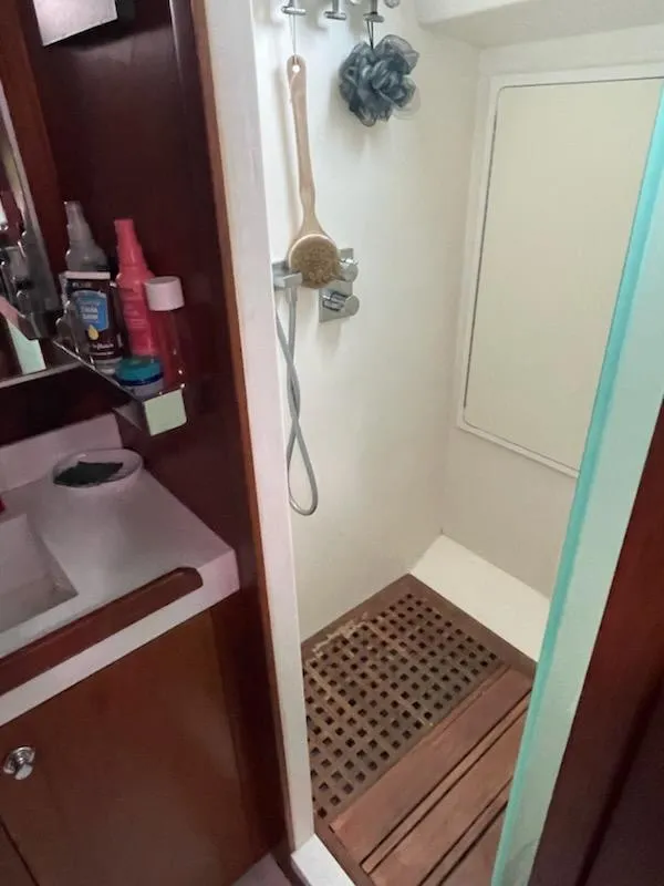 Slide: The Image of Shower area in 2014 Seaton Custom Ketch with wooden floor mat and toiletries. - 22