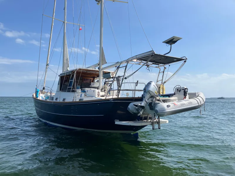 Slide: The Image of Seaton Custom Ketch 2014 sailboat anchored in calm waters under a clear blue sky. - 26