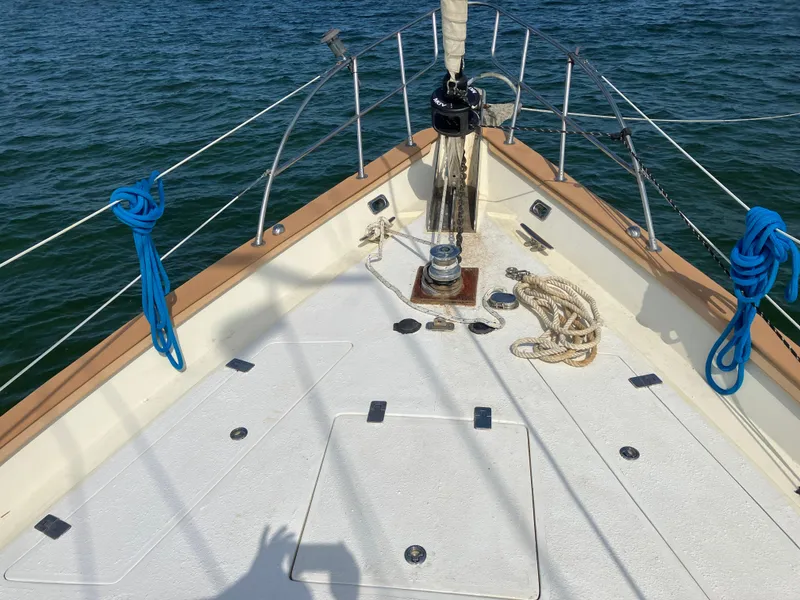 Slide: The Image of Bow of 2014 Seaton Custom Ketch with ropes and winch, sailing on calm waters. - 29