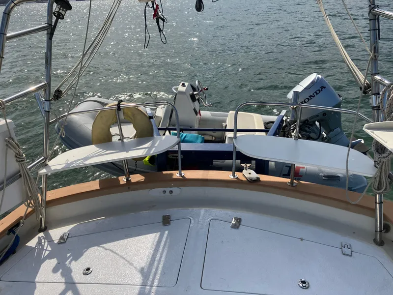 Slide: The Image of Seaton Custom Ketch 2014 with dinghy and Honda outboard motor on calm water. - 31