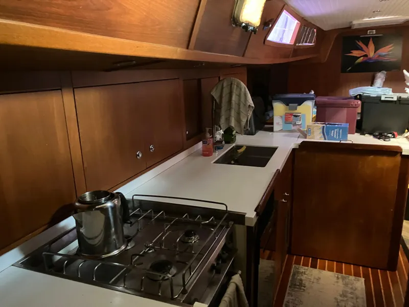 Slide: The Image of Interior of 2014 Seaton Custom Ketch yacht kitchen with stove, sink, and wooden cabinetry. - 34