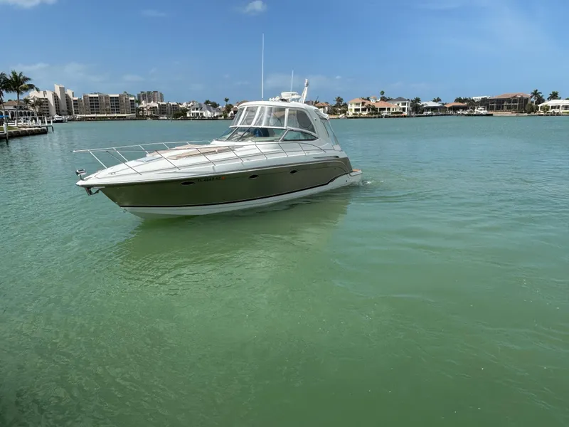 Slide: The Image of 2008 Formula 37 PC yacht cruising in a serene, tropical bay with clear skies. - 12