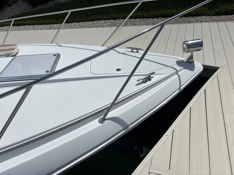 Slide: The Image of 2008 Formula 37 PC boat docked, featuring sleek white deck and stainless steel railings. - 16
