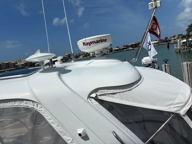 Slide: The Image of 2008 Formula 37 PC yacht with Raymarine radar, docked by a scenic waterfront. - 19