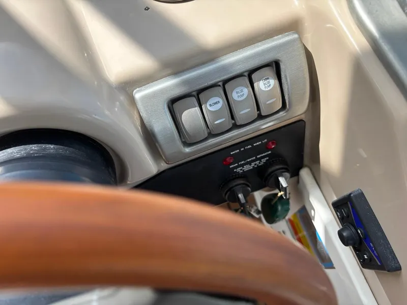 Slide: The Image of Control panel of a 2008 Formula 37 PC boat with switches and steering wheel. - 35