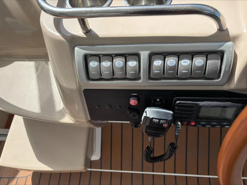 Slide: The Image of Control panel of a 2008 Formula 37 PC boat with switches and radio. - 36