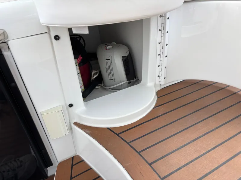 Slide: The Image of 2008 Formula 37 PC boat interior with open storage compartment and wooden flooring. - 43