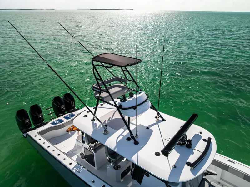 Slide: The Image of 2024 Freeman 42 LR boat on serene green ocean waters, equipped with multiple fishing rods. - 11