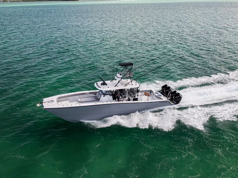 Slide: The Image of 2024 Freeman 42 LR boat cruising on clear turquoise waters. - 12