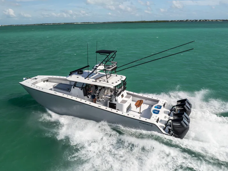 Slide: The Image of 2024 Freeman 42 LR boat cruising on turquoise waters, equipped with powerful outboard engines. - 14