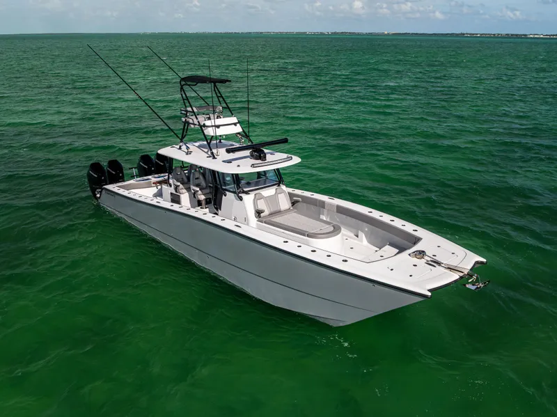 Slide: The Image of 2024 Freeman 42 LR boat on open water, featuring sleek design and multiple outboard engines. - 2