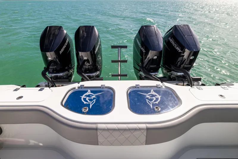 Slide: The Image of 2024 Freeman 42 LR boat with four Mercury outboard engines on turquoise water. - 21