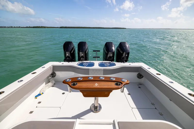 Slide: The Image of 2024 Freeman 42 LR boat with four engines on open water. - 22