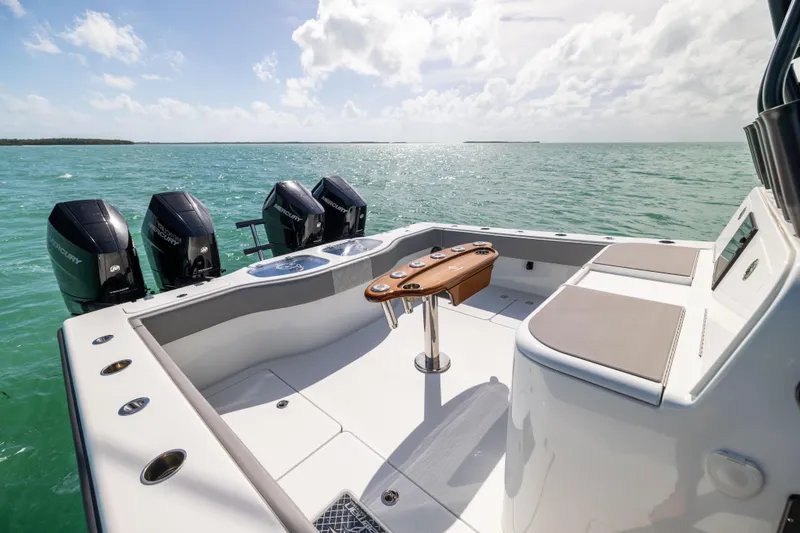 Slide: The Image of 2024 Freeman 42 LR boat deck with four engines, set against a serene ocean backdrop. - 23