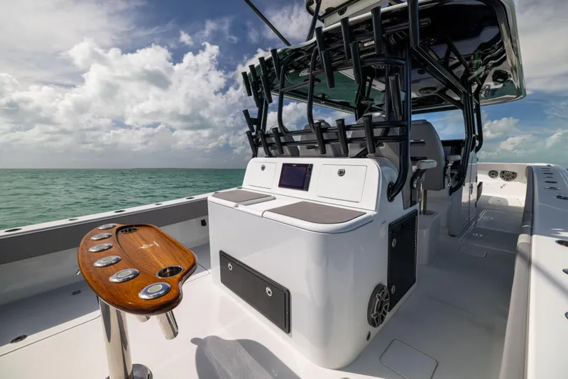 Slide: The Image of 2024 Freeman 42 LR boat interior with fishing rod holders and ocean view. - 27