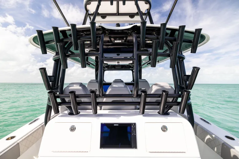 Slide: The Image of 2024 Freeman 42 LR boat with multiple rod holders, cruising on turquoise waters. - 29