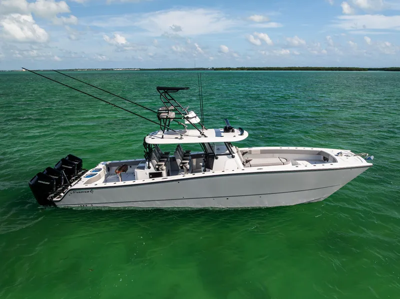 Slide: The Image of 2024 Freeman 42 LR boat on turquoise water, featuring multiple outboard engines. - 3