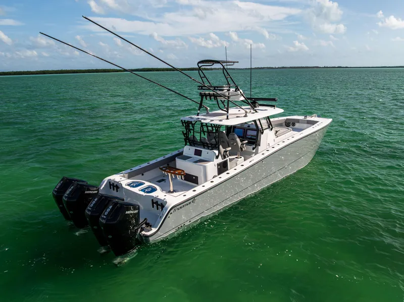 Slide: The Image of 2024 Freeman 42 LR boat on turquoise water, featuring multiple outboard engines. - 4