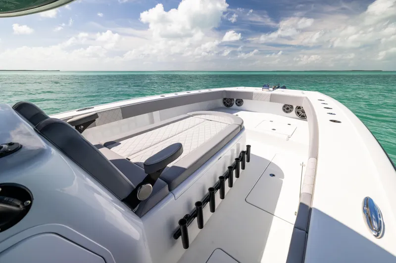 Slide: The Image of 2024 Freeman 42 LR boat interior with ocean view, featuring seating and rod holders. - 44
