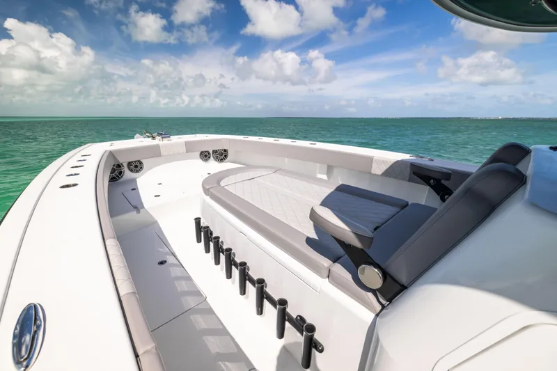 Slide: The Image of Freeman 42 LR 2024 boat deck with seating, rod holders, and ocean view. - 46