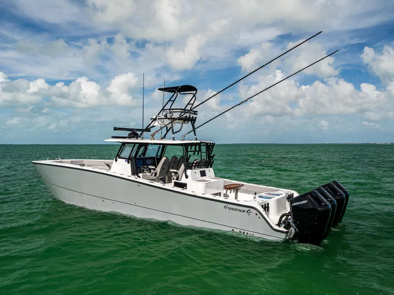 Slide: The Image of 2024 Freeman 42 LR boat on open water, featuring dual outboard motors and fishing equipment. - 7