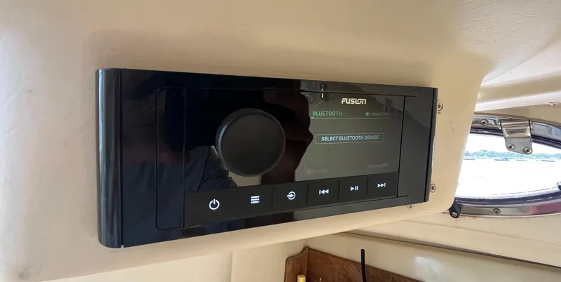 Slide: The Image of Fusion stereo system on 2004 Wellcraft Coastal 252 boat dashboard. - 11