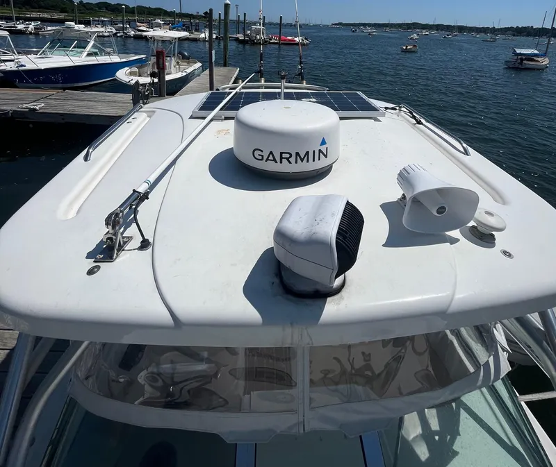 Slide: The Image of 2004 Wellcraft Coastal 252 boat with Garmin equipment docked by the water. - 12