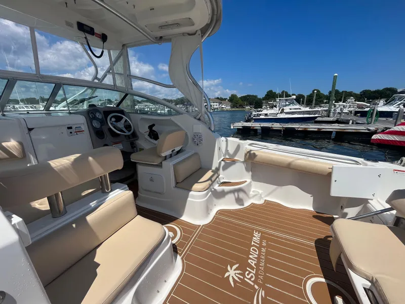 Slide: The Image of 2004 Wellcraft Coastal 252 boat interior with seating, steering wheel, and dock view. - 5