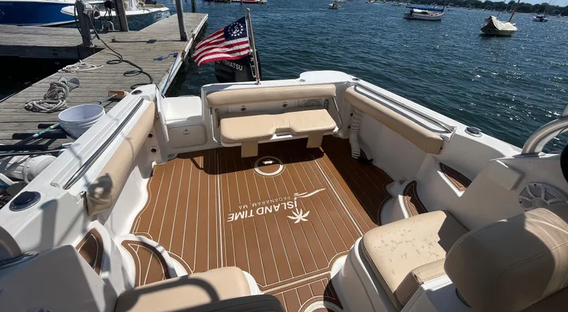 Slide: The Image of 2004 Wellcraft Coastal 252 boat interior with seating, docked by the water. - 6