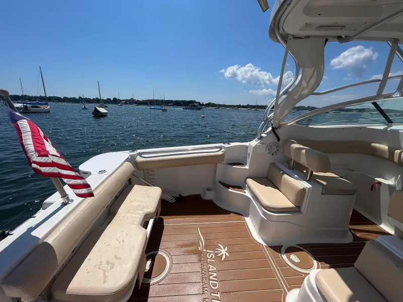 Slide: The Image of 2004 Wellcraft Coastal 252 boat interior with seating, docked on a sunny day. - 7