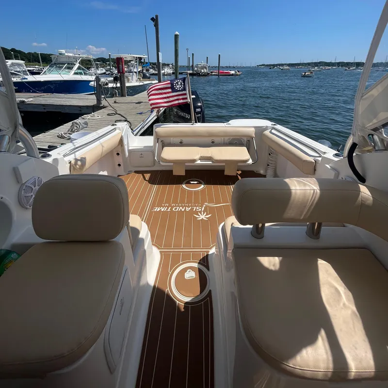 Slide: The Image of 2004 Wellcraft Coastal 252 boat interior with seating, docked by the water. - 8