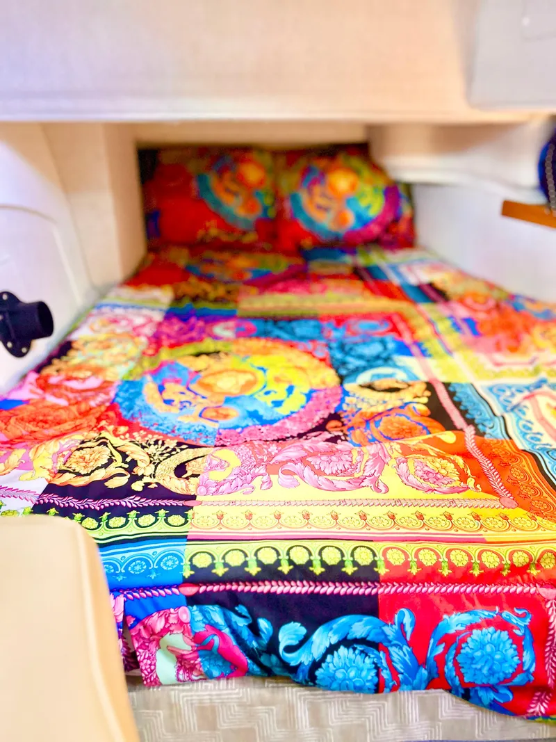 Slide: The Image of 2024 Ranger Tugs R31S cabin with vibrant, colorful bedding. - 20
