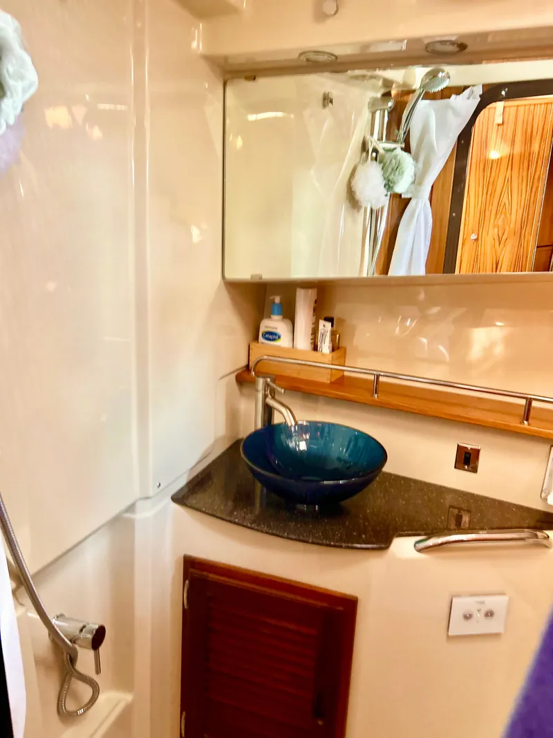 Slide: The Image of 2024 Ranger Tugs R31S bathroom with modern sink and mirror. - 21