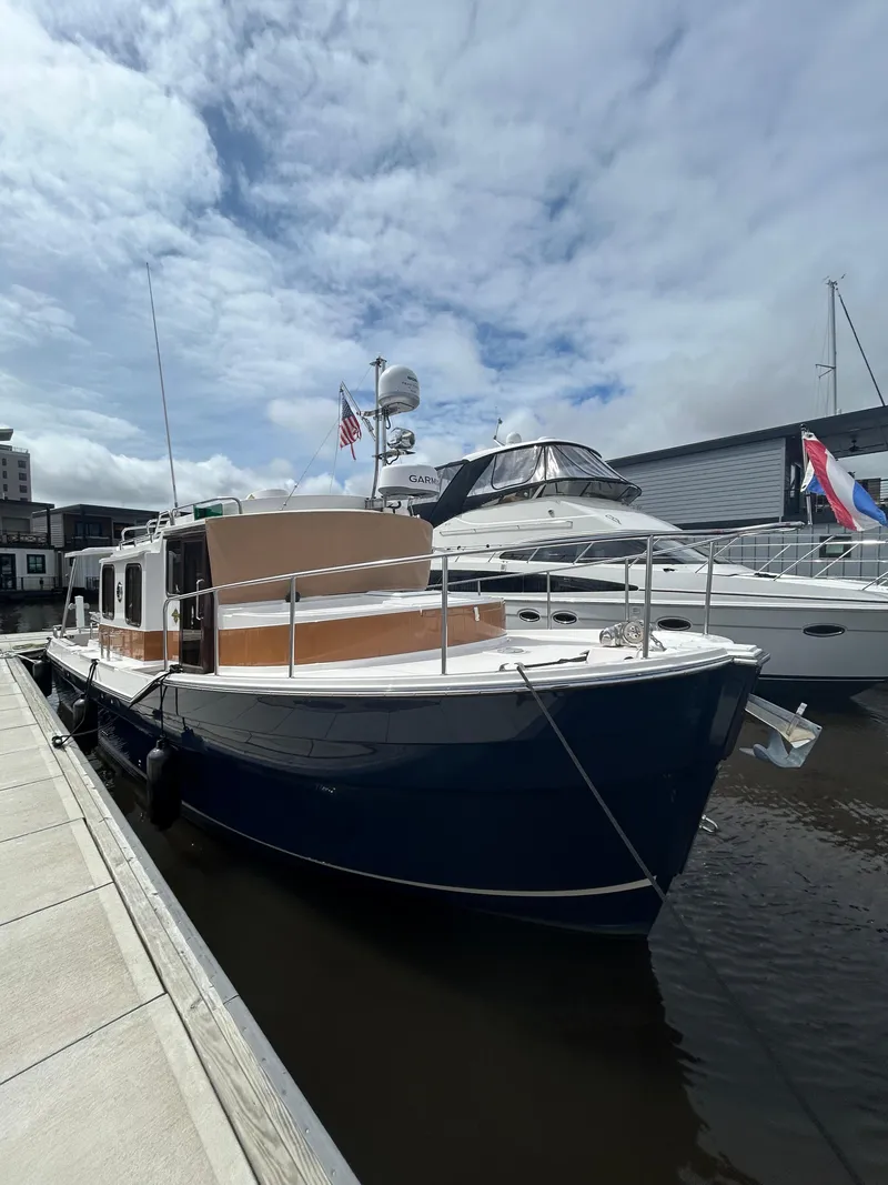 Slide: The Image of 2024 Ranger Tugs R31S docked, showcasing sleek design and modern features. - 27