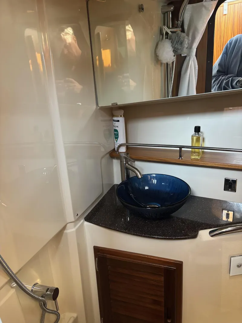 Slide: The Image of 2024 Ranger Tugs R31S bathroom with modern sink and mirror. - 9