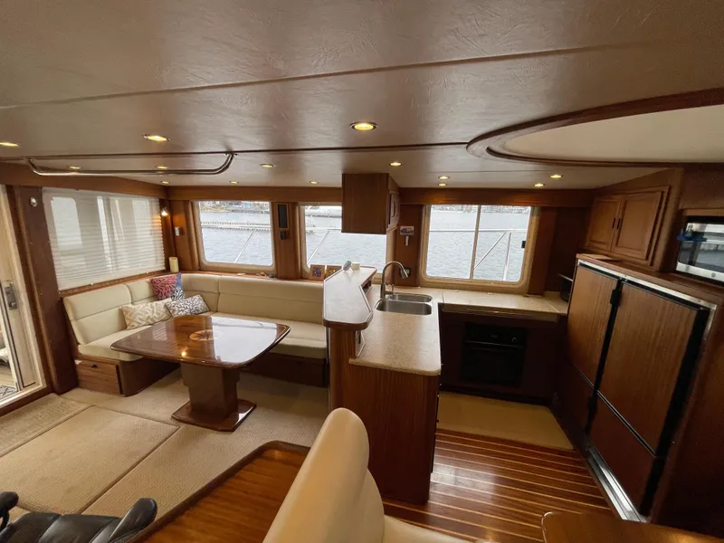 Slide: The Image of Luxurious interior of 2009 American Tug 49 Limited yacht with spacious seating and kitchen area. - 11